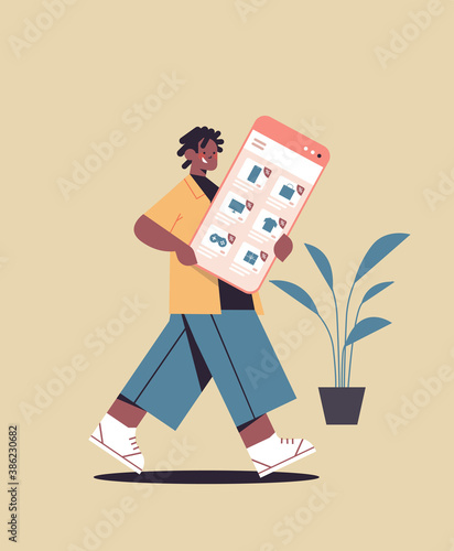 african american man holding smartphone online shopping cyber monday big sale holiday discounts e-commerce concept full length vertical vector illustration © mast3r