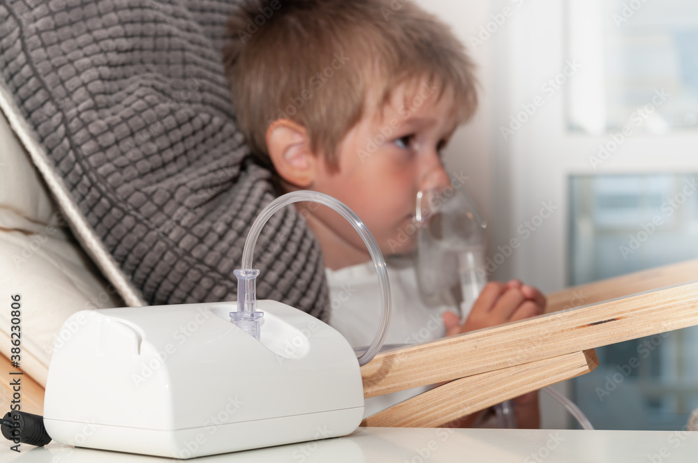 Modern jet nebulizer or atomizer for making inhalation, respiratory procedure by pneumonia or cough for child in home. Treatment at home. Modern jet nebulizer or atomizer for making inhalation, respiratory procedure by pneumonia or cough for child in home. Treatment at home.