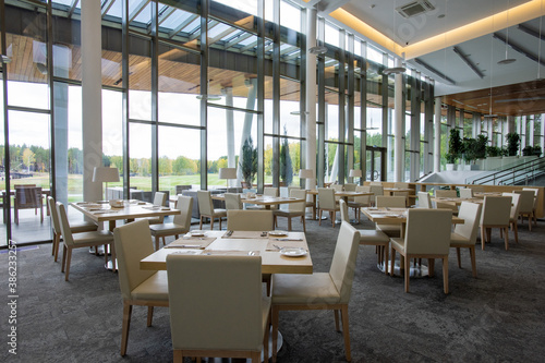 Group of tables served for guests of luxurious restaurant inside business center