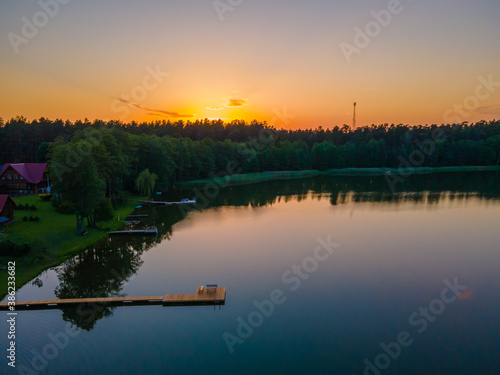 Footbridge to the lake in a sunset © Audrius
