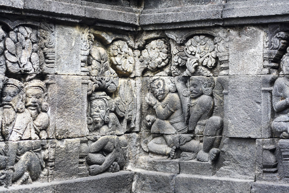 A stone wall relief at Candi Borobudur the largest Buddhist temple in the world.