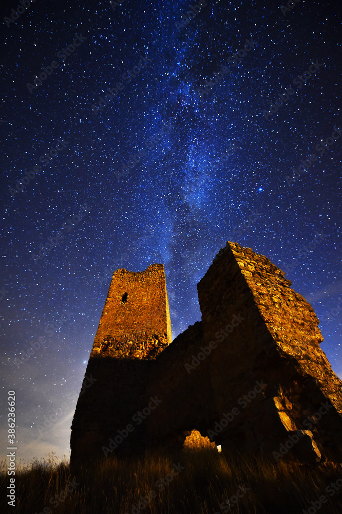 a castle with the milky way in the background