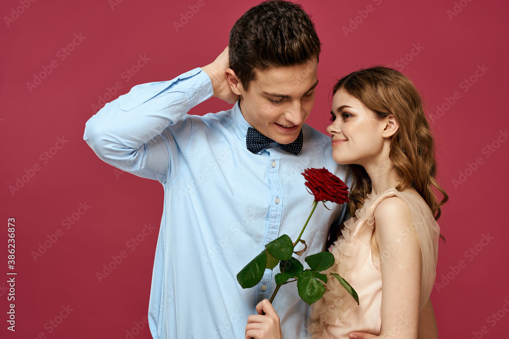 portrait of romantic couple in love with red rose on isolated background and classic suit evening dress portrait of romantic couple in love with red rose on isolated background and classic suit evening dress