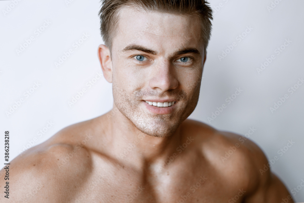 Muscular sexy model sports young man on white background. Portrait of beautiful smiling healthy guy. Muscular sexy model sports young man on white background. Portrait of beautiful smiling healthy guy.