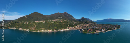 Panoramic view of the historic city of Toscolano Maderno on Lake Garda Italy. Tourist place on Lake Garda in the background Alps and blue sky. Aerial view of the town on Lake Garda. photo