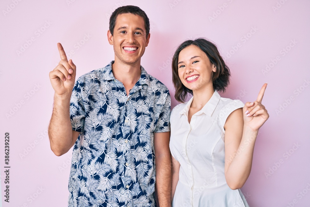 Beautiful couple wearing casual clothes smiling confident pointing with fingers to different directions. copy space for advertisement Beautiful couple wearing casual clothes smiling confident pointing with fingers to different directions. copy space for advertisement