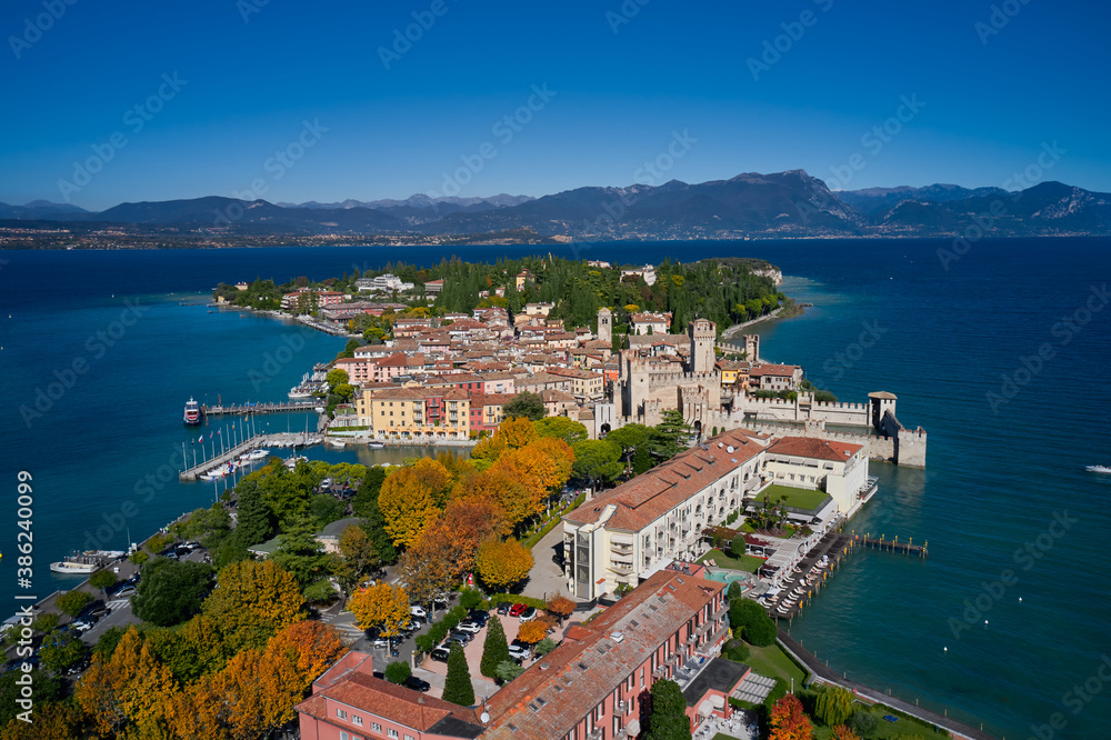 Autumn in Italy on Lake Garda, Sirmione peninsula. Top view of the town of Sirmione, Italy. Lake Garda, a tourist destination in northern Italy. Trees in the autumn season.