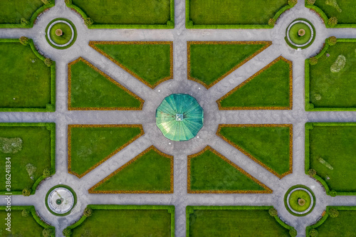 Symmetrial aerial view at a green park with a temple in its center, straight top down from above, popular architecture photo. photo