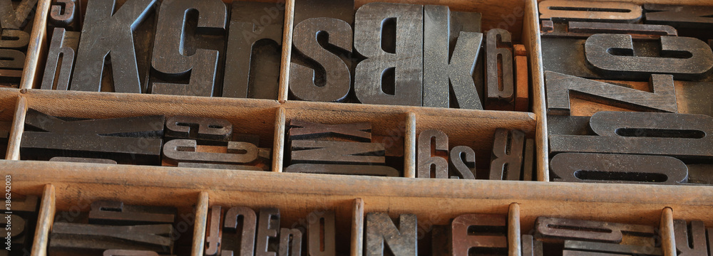 Old letterpess background. Collection of vintage block letters made of
