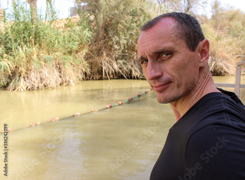 Europian tourist man. View of a baptism site at the Jordan River. photo