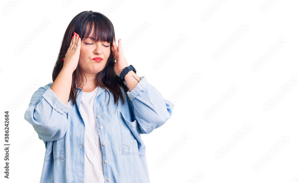 Young plus size woman wearing casual clothes suffering from headache desperate and stressed because pain and migraine. hands on head. Young plus size woman wearing casual clothes suffering from headache desperate and stressed because pain and migraine. hands on head.
