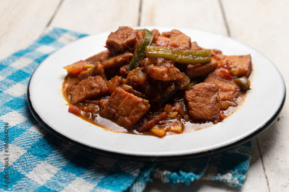 Pork chops with red sauce also called mexicana style on white background Pork chops with red sauce also called mexicana style on white background