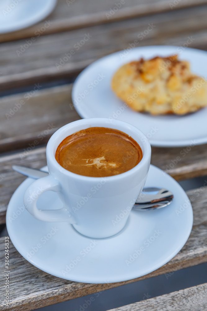 Cup of coffee on table in coffee shop cafe.A cup of coffee and coffee beans with croissant on the table Cup of coffee on table in coffee shop cafe.A cup of coffee and coffee beans with croissant on the table