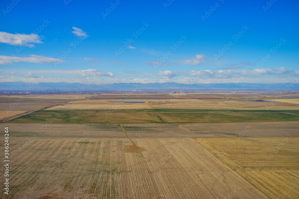 Fototapeta premium Aerial view of of farm in suburban of Denver in Colorado and the country road 