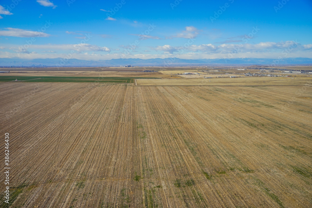 Aerial view of of farm in suburban of Denver in Colorado and the country road 
