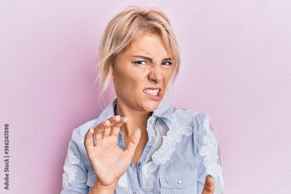 Young blonde girl wearing casual clothes disgusted expression, displeased and fearful doing disgust face because aversion reaction. with hands raised Young blonde girl wearing casual clothes disgusted expression, displeased and fearful doing disgust face because aversion reaction. with hands raised