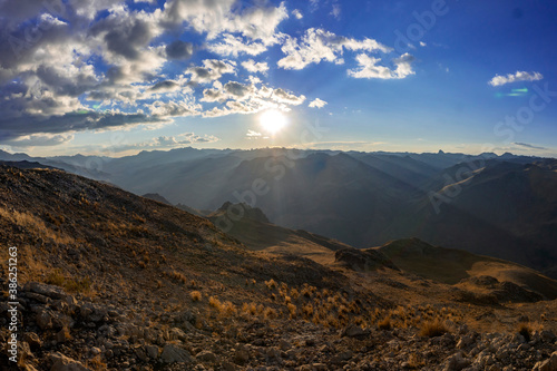 watching the sun go down on the horizon from the top of a hill located in huancavelica peru
