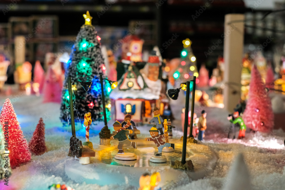 Santa Clause house, xmas holidays, Christmas time, street in snow, miniature of winter scene with houses, people, trees, Christmas concept.