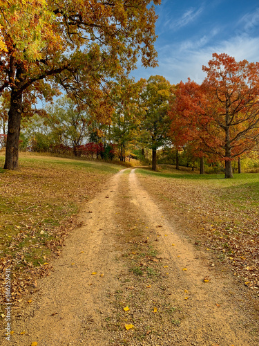 Dirt road through country autumn colors 