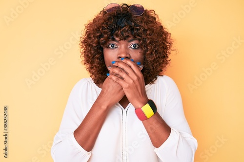 Young african american woman wearing casual clothes shocked covering mouth with hands for mistake. secret concept.