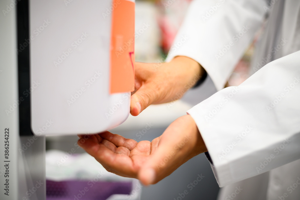 Hand sanitizer alcohol gel rub clean hands hygiene prevention of coronavirus virus outbreak. Man using bottle of antibacterial sanitiser soap. - obrazy, fototapety, plakaty 