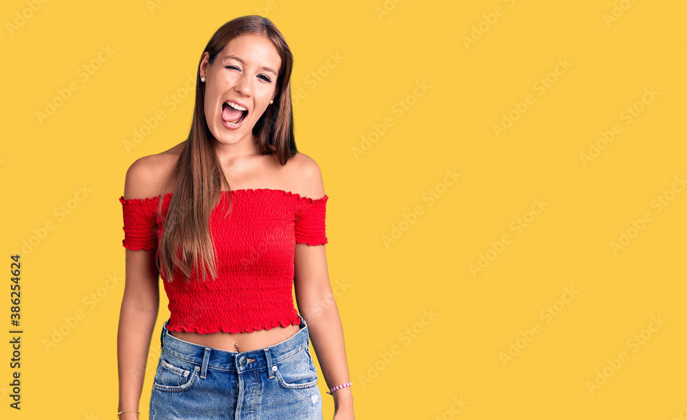Young beautiful hispanic woman wearing casual clothes winking looking at the camera with sexy expression, cheerful and happy face. Young beautiful hispanic woman wearing casual clothes winking looking at the camera with sexy expression, cheerful and happy face.