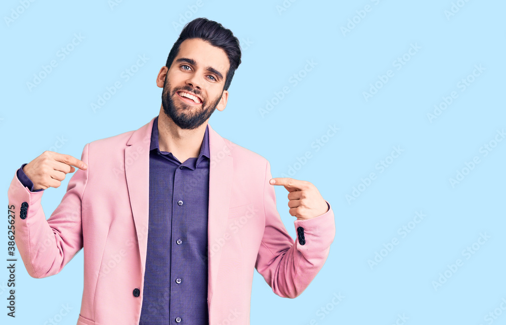 Young handsome man with beard wearing elegant jacket looking confident with smile on face, pointing oneself with fingers proud and happy. Young handsome man with beard wearing elegant jacket looking confident with smile on face, pointing oneself with fingers proud and happy.