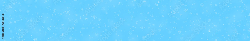 Christmas banner of snowflakes of different shapes, sizes and transparency on light blue background