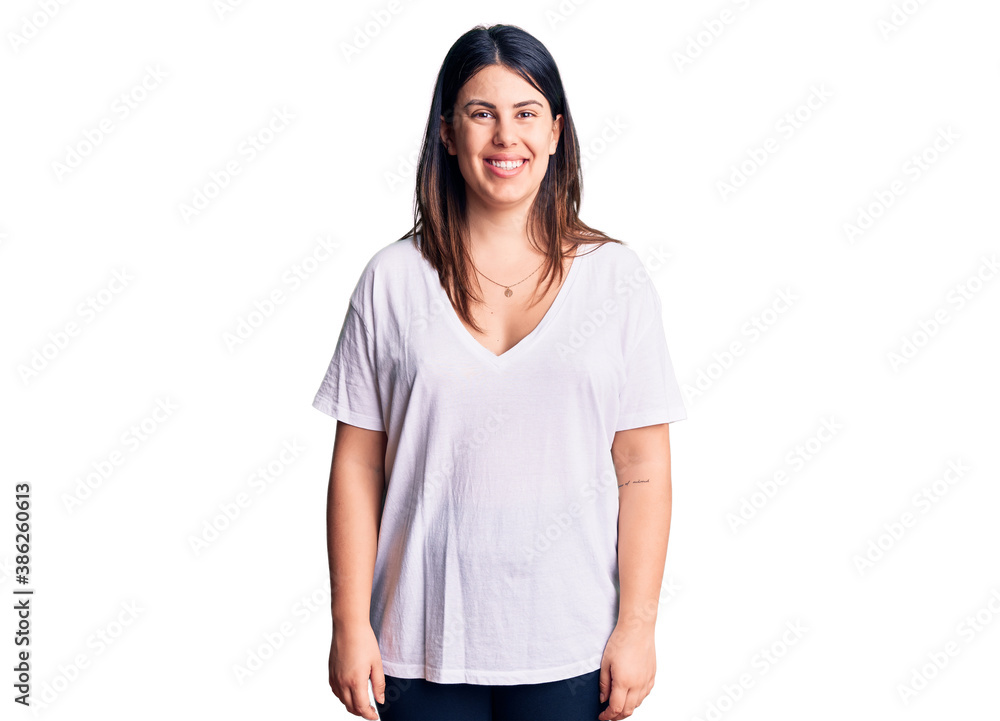 Young beautiful brunette woman wearing casual t-shirt with a happy and cool smile on face. lucky person. Young beautiful brunette woman wearing casual t-shirt with a happy and cool smile on face. lucky person.