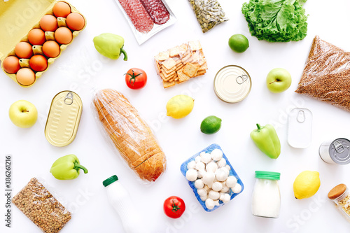 Set of grocery items from canned food, vegetables, cereal on white background. Food delivery concept. Donation concept. Top view.