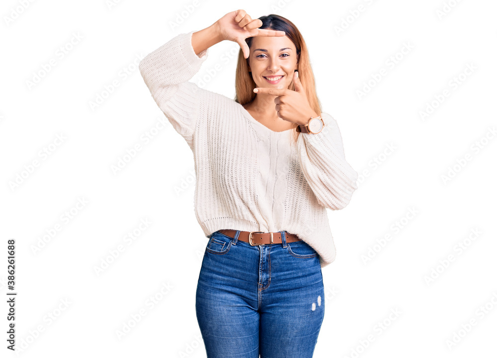 Beautiful young woman wearing casual clothes smiling making frame with hands and fingers with happy face. creativity and photography concept. Beautiful young woman wearing casual clothes smiling making frame with hands and fingers with happy face. creativity and photography concept.