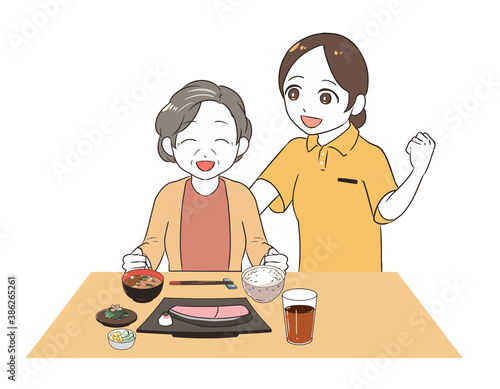 食事を促す女性介護士　笑顔の高齢女性