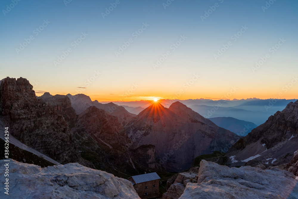 panoramic view at sunrise over the mountain ranges of the dolomites