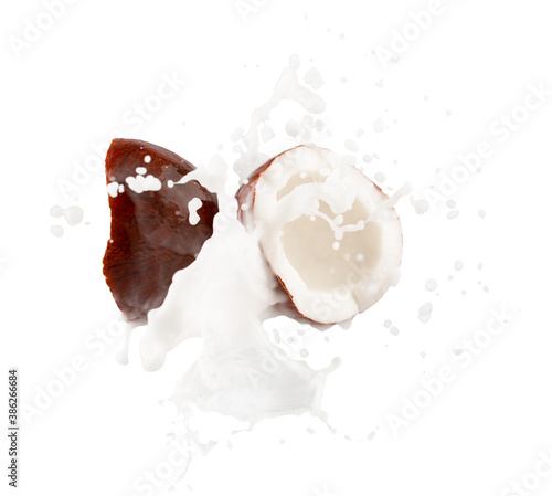 coconut halves with milk splash isolated on a white background