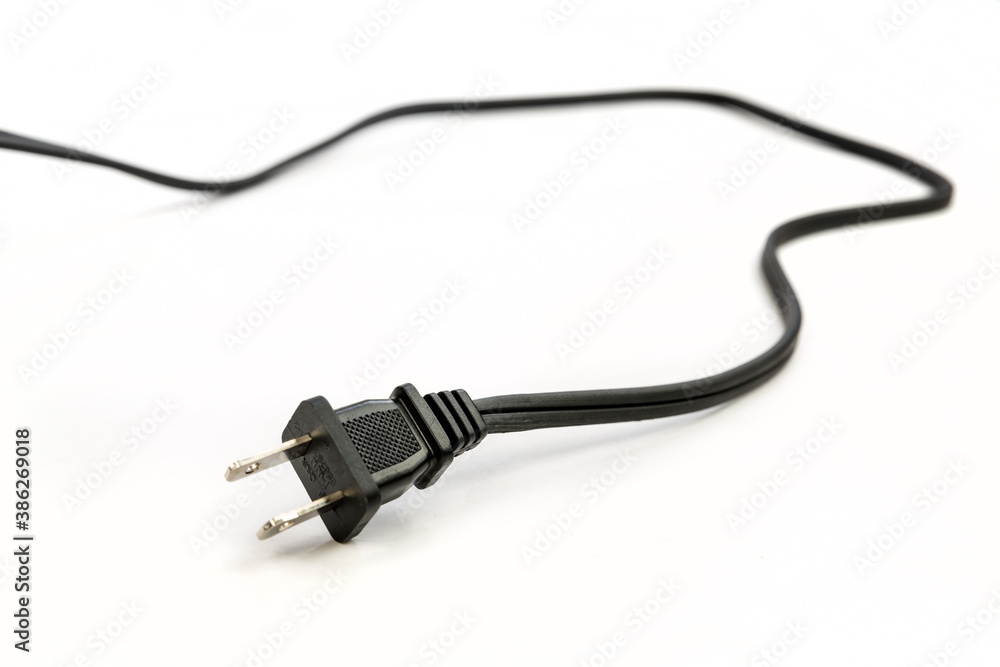 Black two pronged power cord trailing off into the distance shallow depth of field Black two pronged power cord trailing off into the distance shallow depth of field