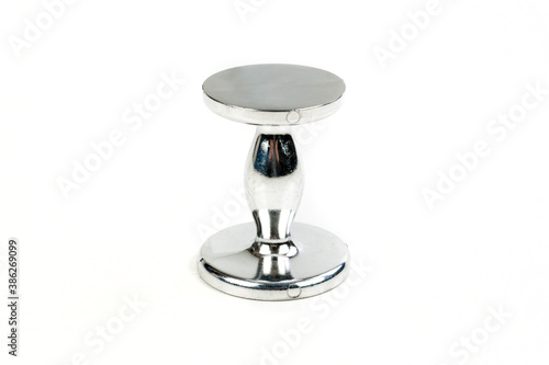 Coffee tamper standing on end isolated on a white surface