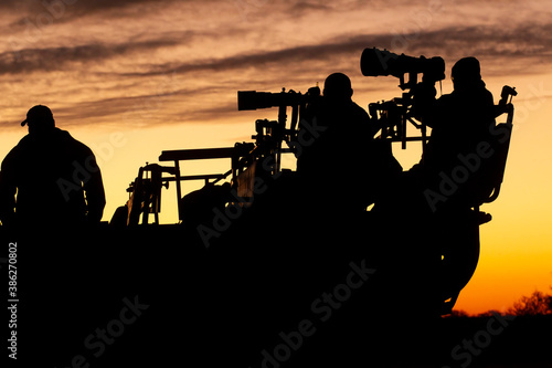 Photographers with their cameras on a safari in South Africa at sunset