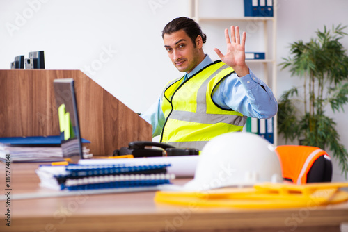 Young male architect working in the office