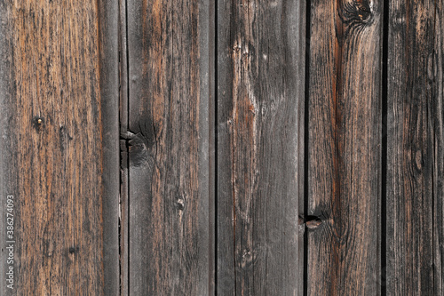 Old dark brown wooden plank, natrual hardwood weathered, space for text. close up and no person 