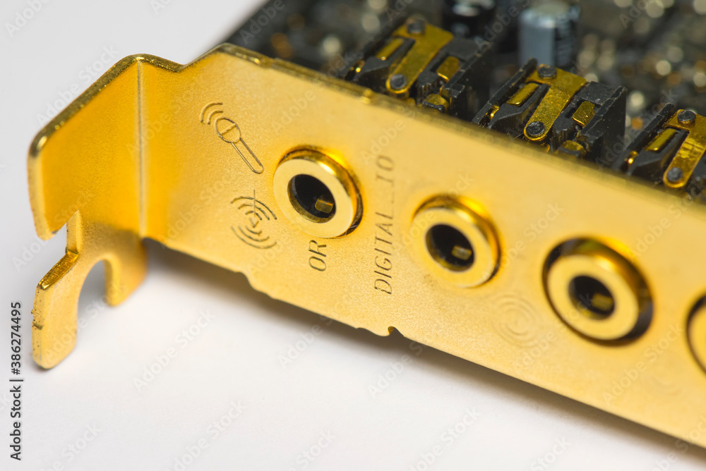 Golden computer sound card panel with input and output audio ports
