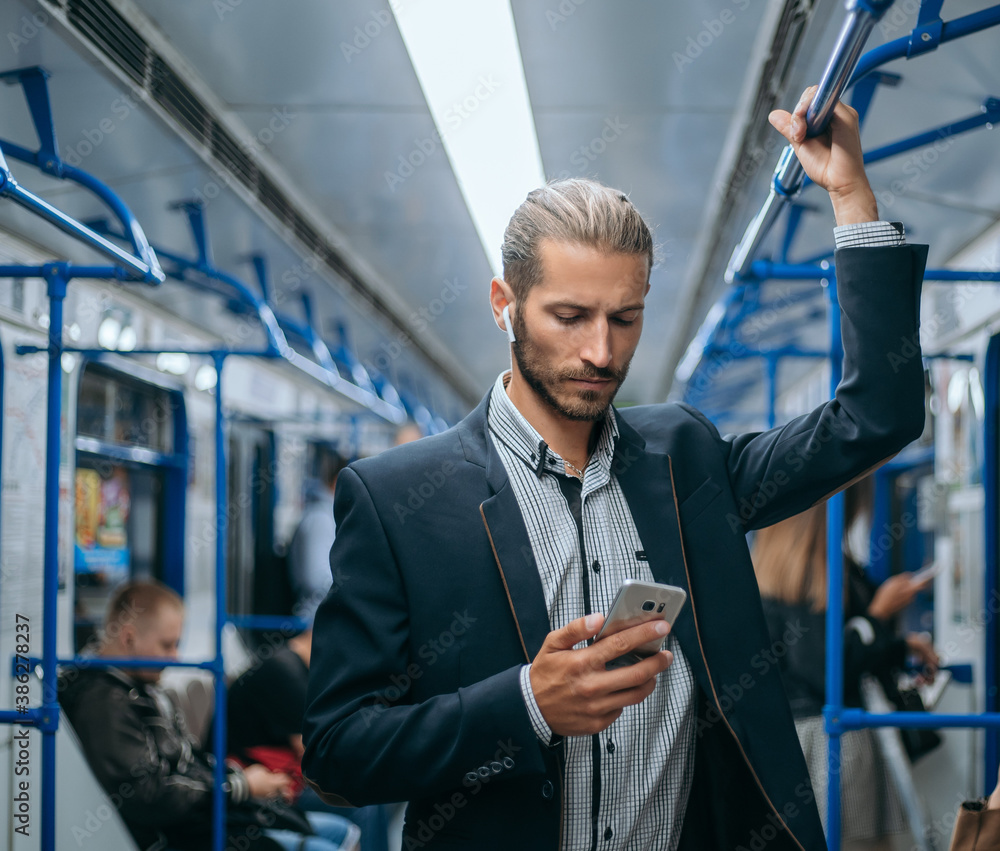 business man reading his e-mail correspondence in the subway.