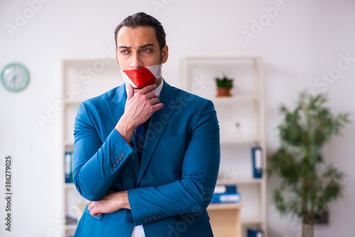 Mouth closed male employee working in the office