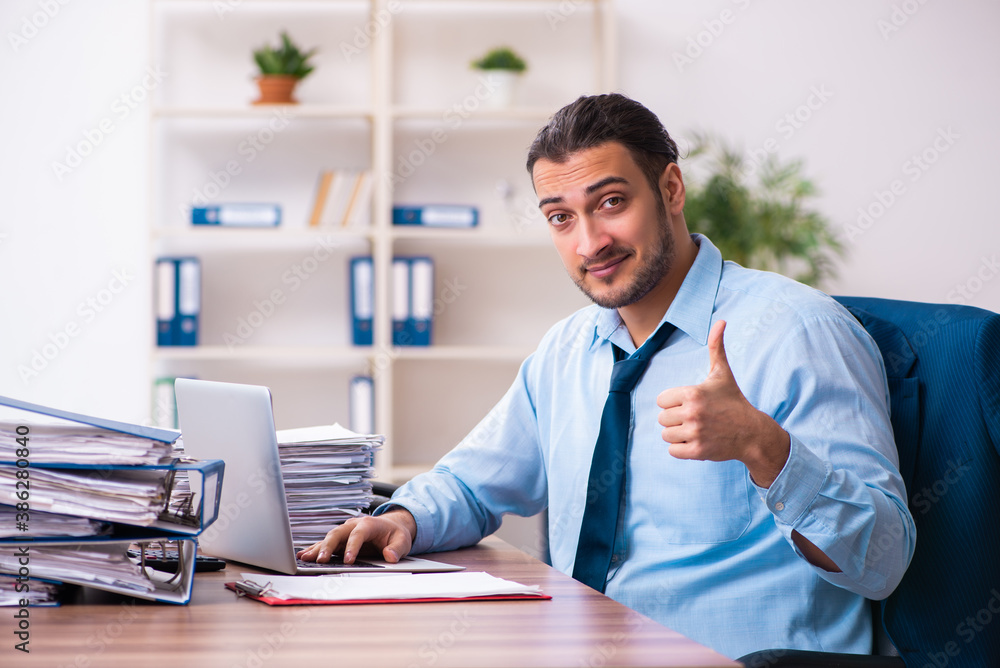 Young male businessman employee working in the office Young male businessman employee working in the office