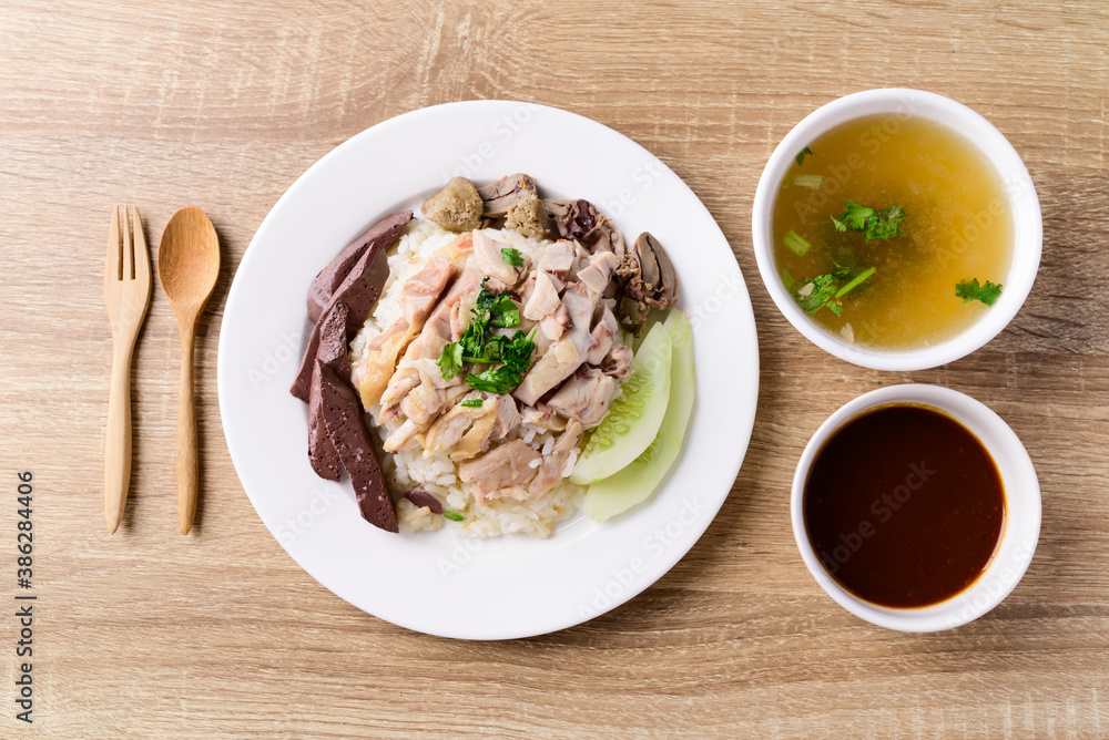 Thai cuisine (Khao Man Kai), Hainanese chicken rice eating with chili sauce and chicken soup, Top view Thai cuisine (Khao Man Kai), Hainanese chicken rice eating with chili sauce and chicken soup, Top view