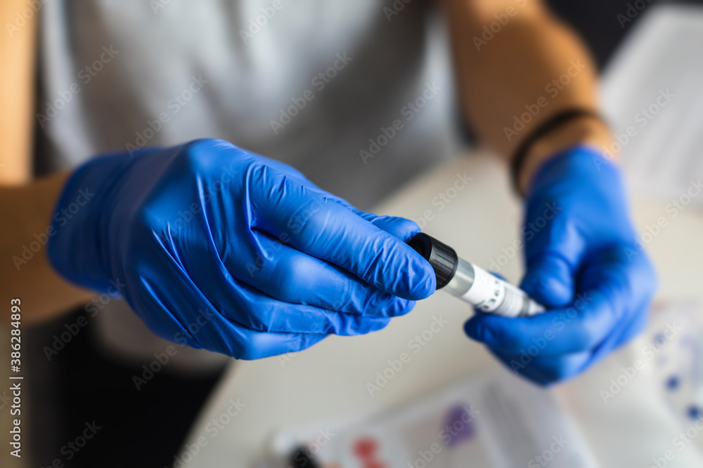 Process of coronavirus testing examination at home, COVID-19 swab collection kit, test tube for taking OP NP patient specimen sample, testing carried out, patient receiving a corona test Process of coronavirus testing examination at home, COVID-19 swab collection kit, test tube for taking OP NP patient specimen sample, testing carried out, patient receiving a corona test