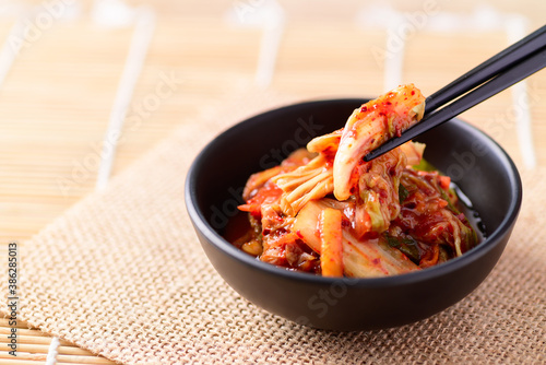 Korean food, Kimchi cabbage in a bowl eating with chopsticks