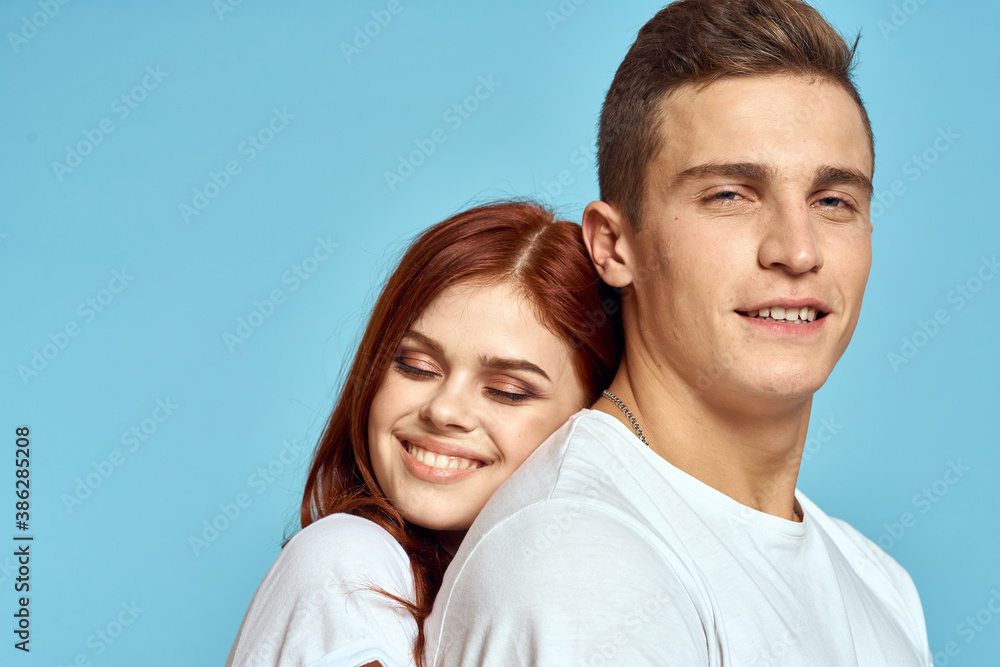 young family love hug cropped view blue background close-up young family love hug cropped view blue background close-up
