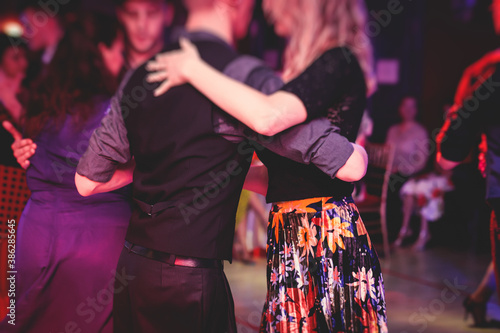 Print op canvas Couples dancing traditional latin argentinian dance milonga in the ballroom, tan