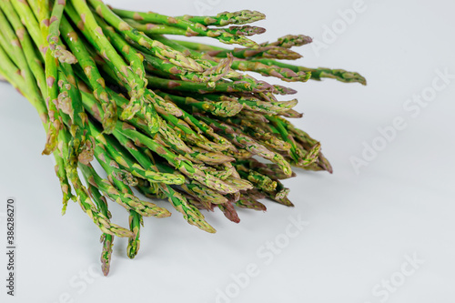 Fresh organic green asparagus sprouts on white isolated background.