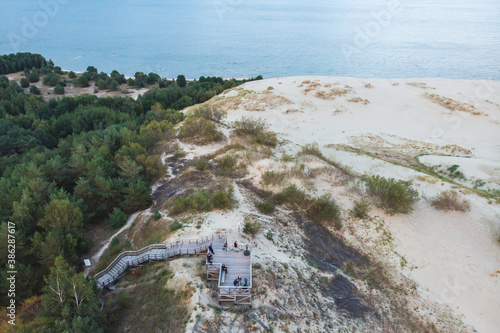 View of sand dunes of Curonian Spit, Kurshskaya Kosa National Park, Curonian Lagoon and the Baltic Sea, Kaliningrad Oblast, Russia and Klaipeda County, Lithuania, summer day photo